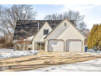 House exterior with double garage and snowy driveway at 138 Fairway Dr, Indianapolis, IN 46260