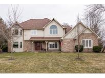 Charming two-story home with brick accents, a covered porch, and a well-manicured lawn at 13955 Springmill Ponds Cir, Carmel, IN 46032