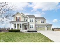 Two story house with a three car garage and landscaped lawn at 14379 Pendragon Way, Fishers, IN 46037