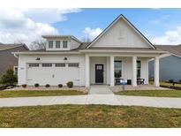 Charming one-story white home with a welcoming front porch and a well-manicured lawn at 19349 Sumrall Pl, Westfield, IN 46074