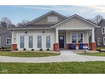 Charming single-story home with a welcoming front porch, red brick accents and a well-manicured lawn at 19365 Sumrall Pl, Westfield, IN 46074