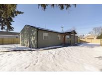 Gray house with new landscaping, snow-covered yard, and a wooden fence at 240 E Caven St, Indianapolis, IN 46225