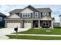 Charming two-story home featuring a manicured lawn, brick accents, and a welcoming front porch at 5442 W Turnbuckle Pl, McCordsville, IN 46055