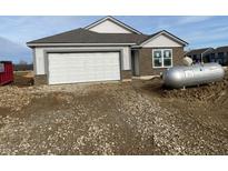 Newly constructed home with gray siding, stone accents, and a two-car garage at 6618 Sulgrove Pl, Indianapolis, IN 46221