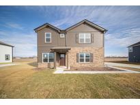 Charming two-story home featuring brown siding, brick accents, and a well-manicured lawn at 7872 Magnolia St, New Palestine, IN 46163