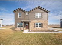 Charming two-story home featuring brown siding, brick accents, well-manicured lawn, and inviting front entrance at 7872 Magnolia St, New Palestine, IN 46163
