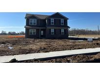 Two-story home featuring a brick facade, gray siding, and a well-manicured front yard at 7925 Magnolia St, New Palestine, IN 46163