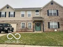 Two-story brick home with attached garage and landscaped lawn at 868 N Shore Blvd, Franklin, IN 46131