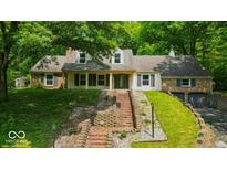 Inviting two-story home with brick and siding, front porch, landscaped yard and attached two-car garage at 9210 Briarclift Rd, Indianapolis, IN 46256