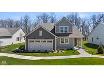 Charming two-story home with landscaped yard and a two-car garage in a suburban neighborhood at 19357 Sumrall Pl, Westfield, IN 46074