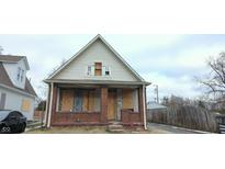 Brick home with boarded windows, needing renovation at 3324 E Vermont St, Indianapolis, IN 46201