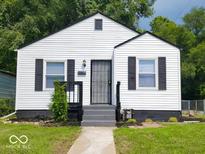 Charming single-story home featuring a white exterior, black shutters, and a well-maintained front yard at 3501 Caroline Ave, Indianapolis, IN 46218