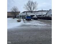 Ranch home with a spacious front yard, driveway, and detached garage at 3517 N Miami Ave, Muncie, IN 47303