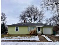 Ranch home with light green siding, attached garage, and a small front yard at 4 Lincoln Dr, Brownsburg, IN 46112