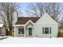 Charming ranch home with a newly painted exterior, updated front door, and snowy front yard at 5272 Cornelius Ave, Indianapolis, IN 46208