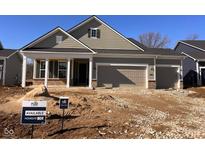 Charming one-story home with a two-car garage, covered porch, and attractive exterior in a developing community at 5780 Stetson Dr, Whitestown, IN 46052