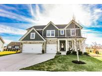 Beautiful two-story home with stone and gray siding, two-car garage, and well-manicured lawn under a blue sky at 8503 Ironhill Ct, Indianapolis, IN 46259