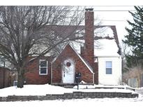 Brick and siding house with snow covered roof and yard at 906 Raible Ave, Anderson, IN 46011