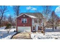 Brick two-story house with attached garage, snowy landscape at 12346 Croquet Way, Indianapolis, IN 46235