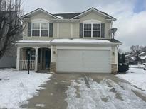 Two-story house with attached garage, snowy yard, and neutral siding at 1330 Lake Meadow Dr, Indianapolis, IN 46217