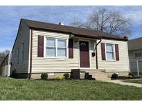Charming home featuring a well-manicured lawn, vinyl siding, and delightful curb appeal at 1612 E Raymond St, Indianapolis, IN 46203