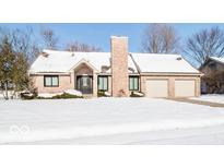 Brick ranch home with snow covered lawn and attached two-car garage at 1966 Broadmoor Ln, Columbus, IN 47203