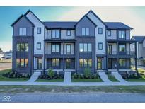 Modern townhomes with brick and siding facade, black trim, and small front gardens at 373 S Cherry St, Westfield, IN 46074