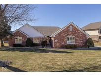 Charming brick ranch home with a well-manicured lawn and mature landscaping at 5211 Summerfield Crossing, Greenwood, IN 46143