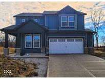 New two-story home with navy siding, white trim, a covered porch, and a two-car garage at 6879 Seabiscuit Rd, Whitestown, IN 46075
