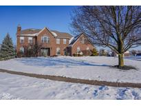 Brick two-story house with a snow-covered lawn at 722 Schmitt Rd, Indianapolis, IN 46239