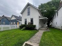 Charming two-story home with landscaped yard and inviting walkway to a cozy front porch at 1125 Laurel St, Indianapolis, IN 46203
