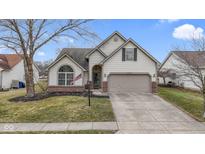 Charming single-Gathering home with a well-manicured lawn and attached two-car garage at 13494 Forum Meadows Dr, Carmel, IN 46033