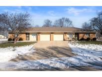 Two-unit brick building with attached garages at 1902 Alhambra Dr, Anderson, IN 46013