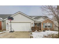 Brick and vinyl ranch home with attached garage and basketball hoop at 3865 Dusty Sands Rd, Whitestown, IN 46075