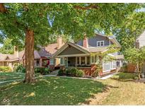 Gray craftsman home with brick porch and mature trees at 5337 N Park Ave, Indianapolis, IN 46220