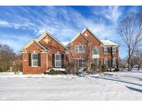 Brick two-story house with snow-covered lawn at 11647 Antone Ct, Fishers, IN 46040