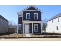 Charming two-story home with a welcoming front porch and neatly landscaped yard, perfect for a Gathering at 1713 Real St, Indianapolis, IN 46240