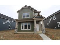 Charming two-story home featuring a covered entryway and craftsman-style architecture, great curb appeal at 1717 Real St, Indianapolis, IN 46240