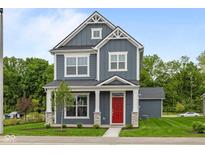 Charming two-story home with a red front door, gray siding, white trim, and manicured lawn at 1721 Real St, Indianapolis, IN 46240