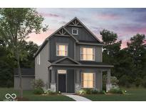 Two-story home with gray siding, stone accents, and a welcoming front porch at 1721 Real St, Indianapolis, IN 46240