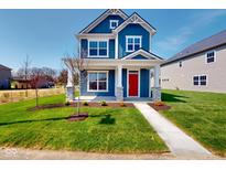 Charming two-story home boasting blue siding, white trim, a red front door, and a well-manicured lawn at 1721 Real St, Indianapolis, IN 46240