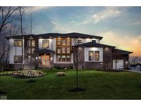 Stunning modern home with brick and white exterior, featuring a landscaped lawn at 4292 Alderborough Way, Zionsville, IN 46077