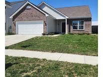 Charming single-story home with a well-maintained lawn and a two-car garage with a brick facade at 5154 Bramwell Ln, Whitestown, IN 46075
