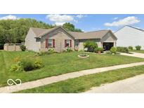 Brick ranch home with landscaped yard and attached garage at 6540 Avalon Blvd, Avon, IN 46123