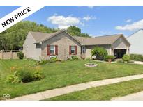 Charming single-story home with a well-manicured front yard and delightful curb appeal, featuring flower-filled window boxes at 6540 Avalon Blvd, Avon, IN 46123
