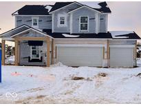 Two-story house with a three-car garage and snow covered front yard at 7194 Firestone Rd, Whitestown, IN 46052