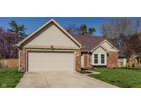 Charming brick and siding home featuring a two-car garage and well-maintained lawn at 8104 Pocket Hollow Ct, Indianapolis, IN 46256
