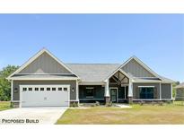Craftsman style home with gray siding, white garage door, and covered porch at Lot 34 Doe Meadow Dr, Anderson, IN 46011