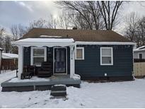 Charming bungalow with covered porch, situated on a snow-covered lot at 3016 N Temple Ave, Indianapolis, IN 46218