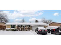 Ranch house with snow covered roof and yard, two car garage and driveway at 3153 Arbutus Dr, Indianapolis, IN 46224